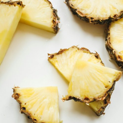 Close-up of juicy pineapple slices showing texture and vibrant yellow color.